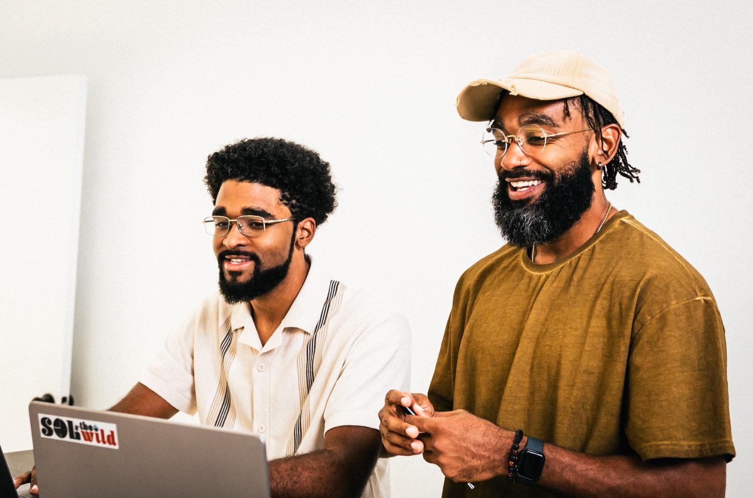 Kameron and Kinan Adams working together at a laptop